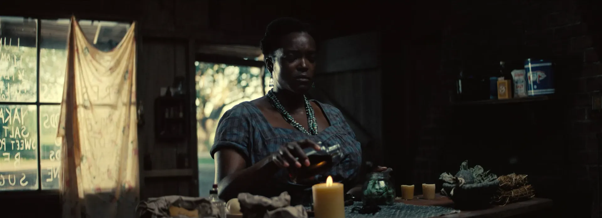 Annie mixing hoodoo remedy by candlelight.